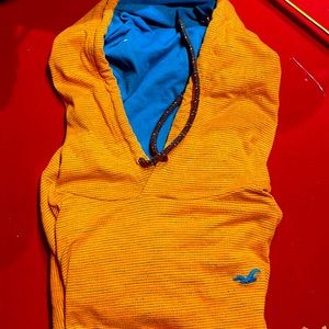 Long sleeve shirt with hoody and pockets.  Pockets don’t zip.  Orange/aqua